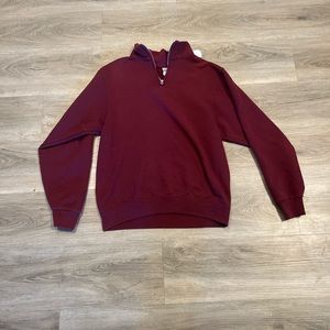 Red quarter zip small discoloration on back and on sleeve pretty unnoticeable